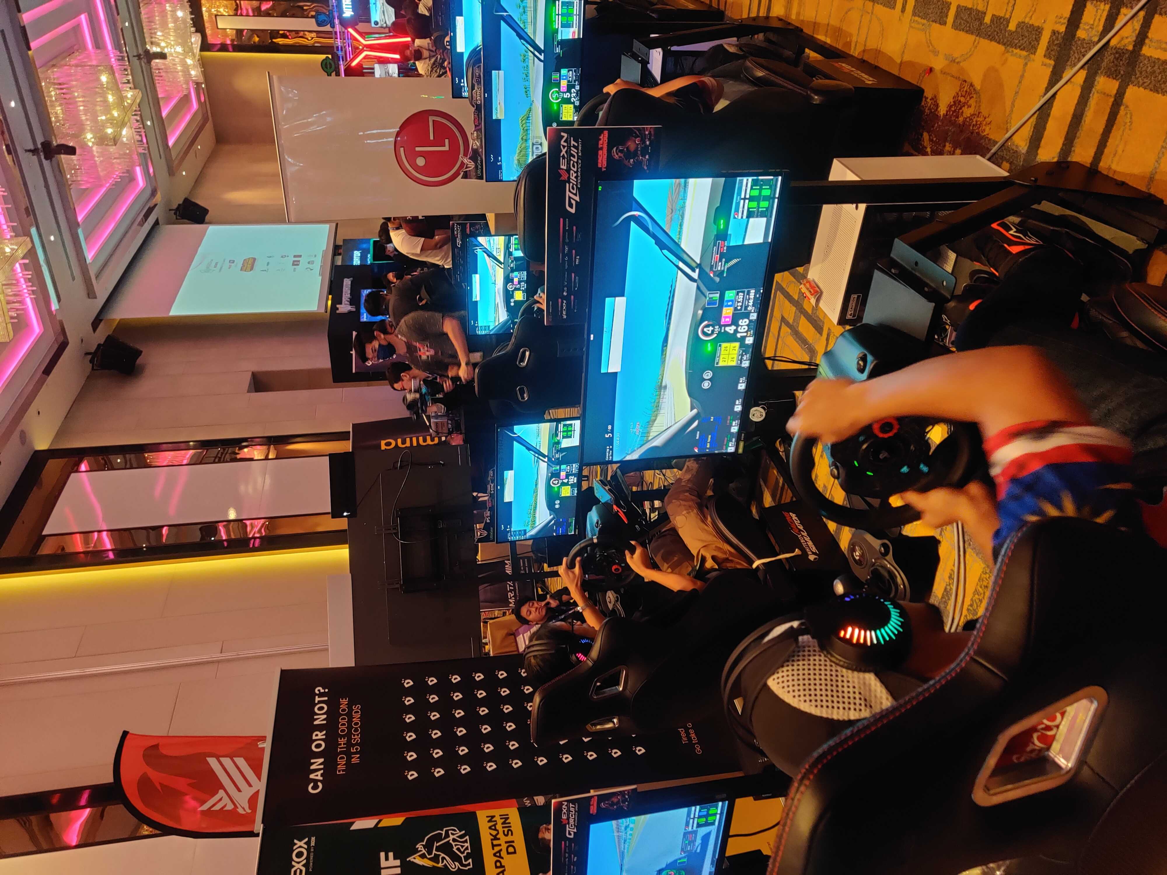 Guests competing on sim racing rig at an expo